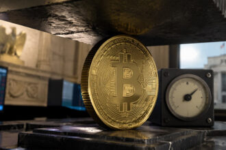 Bitcoin coin pinned beneath a heavy press beside a pressure gauge in a central bank setting, symbolizing Bitcoin’s recovery running into a Fed ceiling without cheaper money