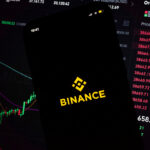 In this photo illustration, an iPhone displays the app and logo of popular cryptocurrency exchange platform Binance, with the desktop version in the background displaying market trends and exchange rates for cryptocurrency Bitcoin on 8th March, 2022 in Leeds, United Kingdom. (photo by Daniel Harvey Gonzalez/In Pictures via Getty Images)